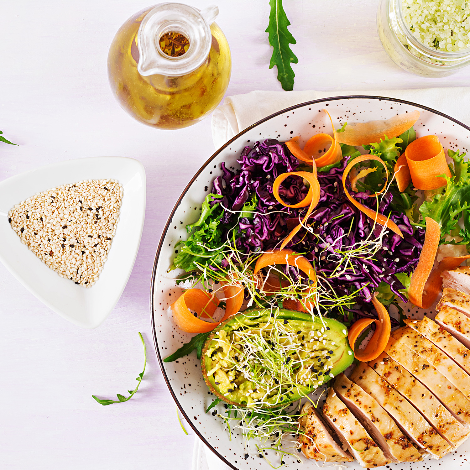 Buddha bowl dish with chicken fillet, avocado, red cabbage, carr